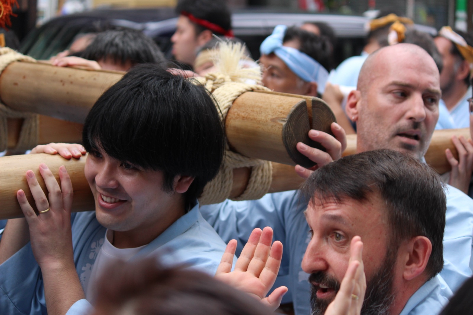 Our guests and locals smiling while carrying the mikoshi poles